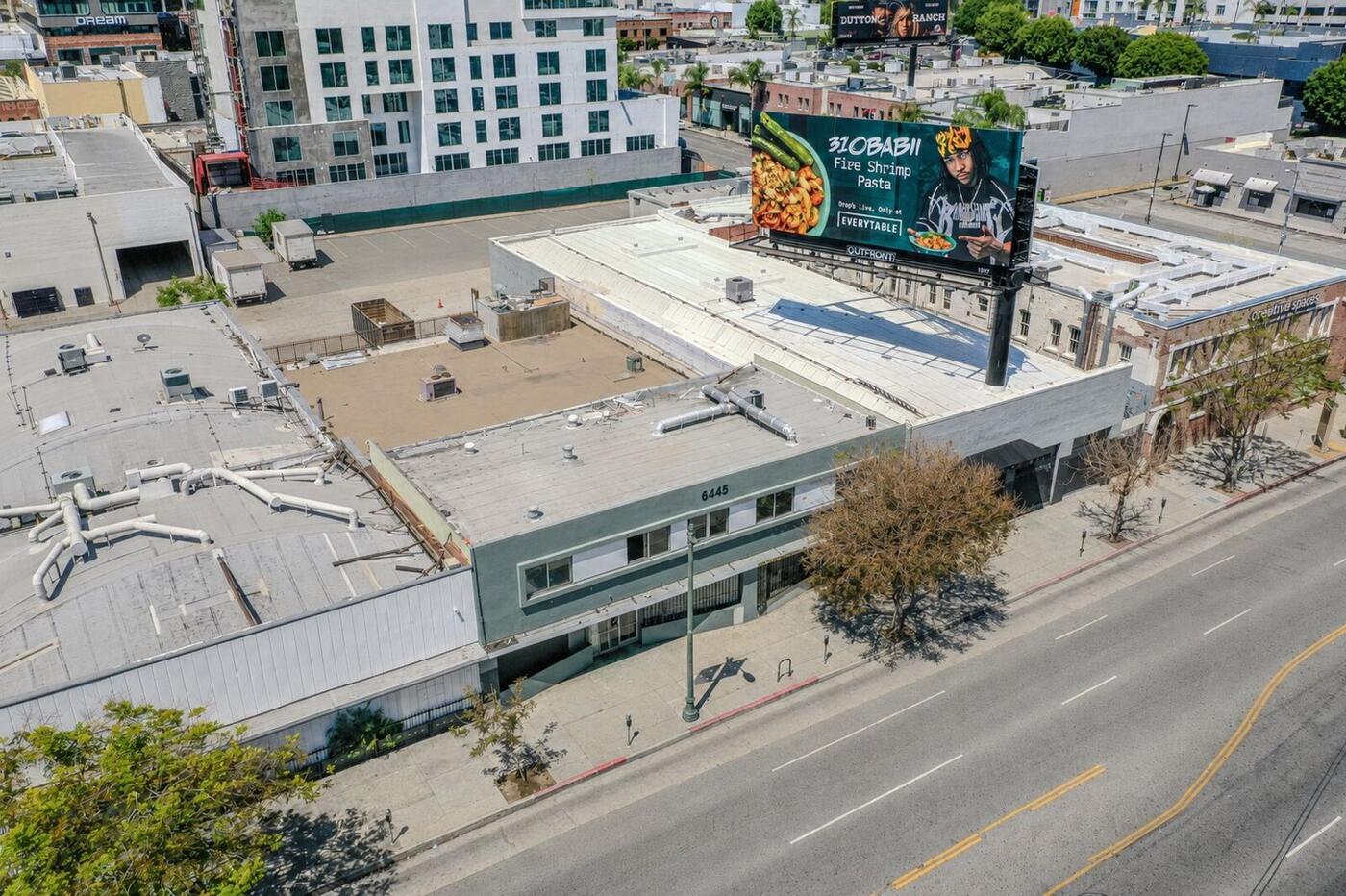 Wide aerial view of Hollywood showing the 6445 W. Sunset Boulevard development site, the Dream Hollywood, and the broader Sunset corridor